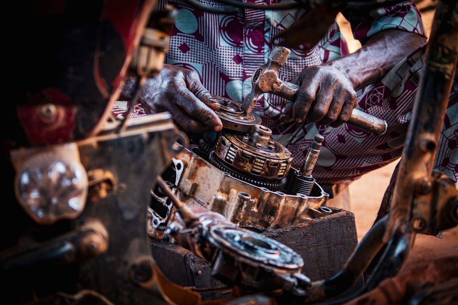 Hands fitting a clutch basket into an opened motorcycle engine